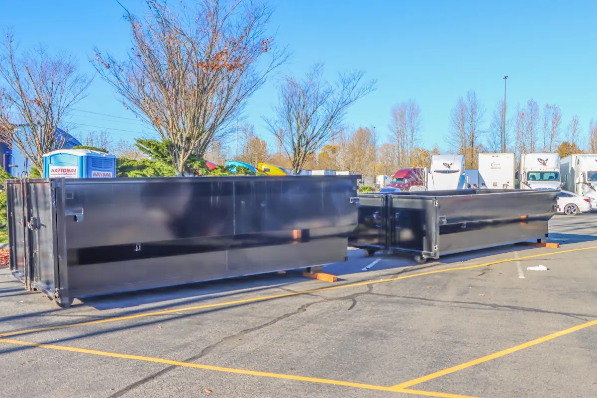 Professional dumpster rental service with roll-off container on residential driveway in Bardmoor